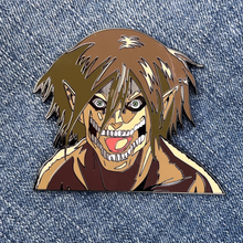Load image into Gallery viewer, 2.5-inch hard-enamel pin of Eren Jaeger in his titan form from the anime Attack on Titan (Shingeki no Kyojin). Front of the pin shown. Nickel pin with black plating. Anime, scout regiment, titans, hunter, yaeger, levi, mikasa, armin, collector, LE, limited run
