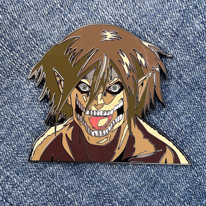 2.5-inch hard-enamel pin of Eren Jaeger in his titan form from the anime Attack on Titan (Shingeki no Kyojin). Front of the pin shown. Nickel pin with black plating. Anime, scout regiment, titans, hunter, yaeger, levi, mikasa, armin, collector, LE, limited run